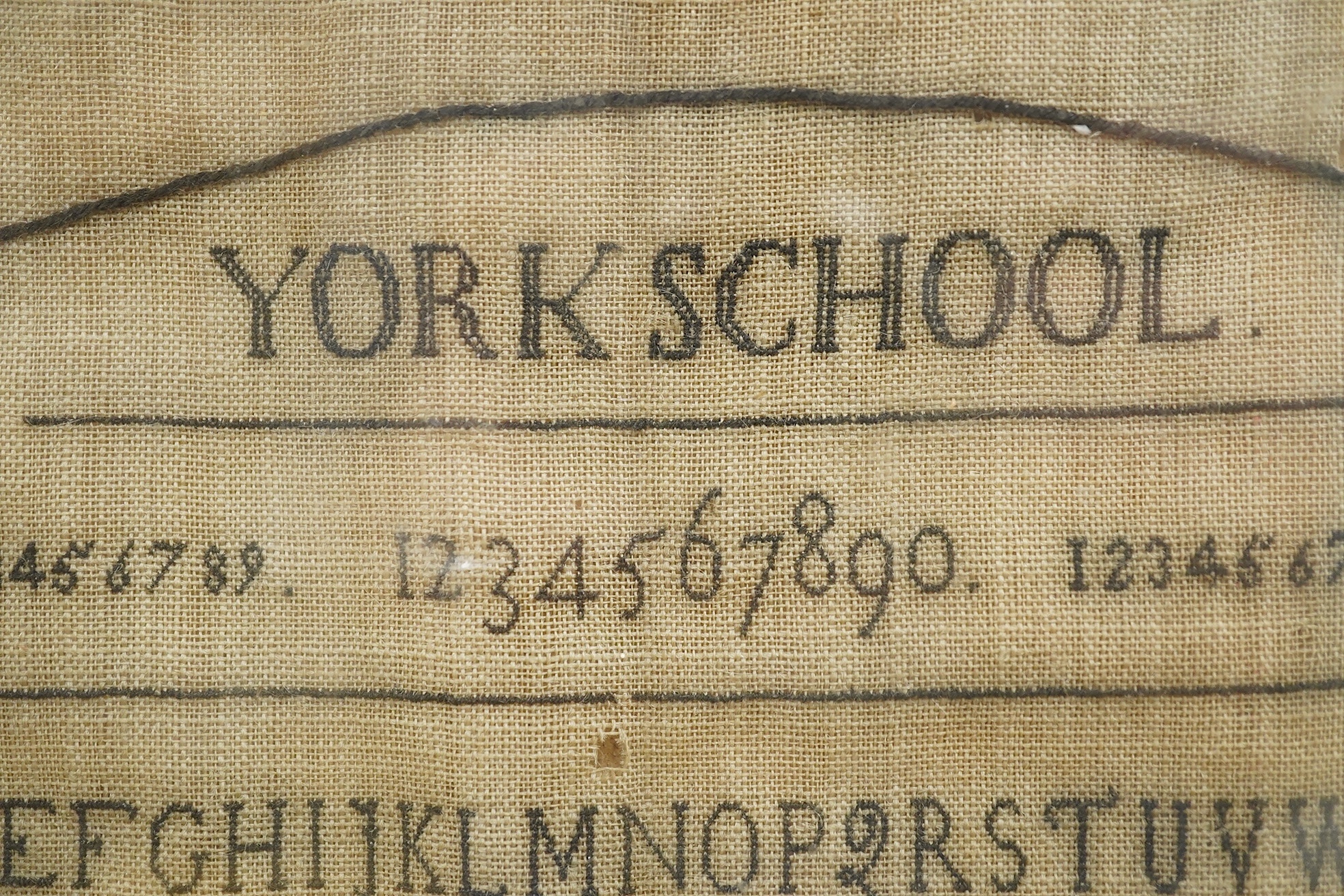 A Hannah Hack, York School, 1801 sampler, sewn within an embroidered black oval border, headed with York School above a row of numerals and two rows of lower case and capital letters, with a pastoral verse below then sig